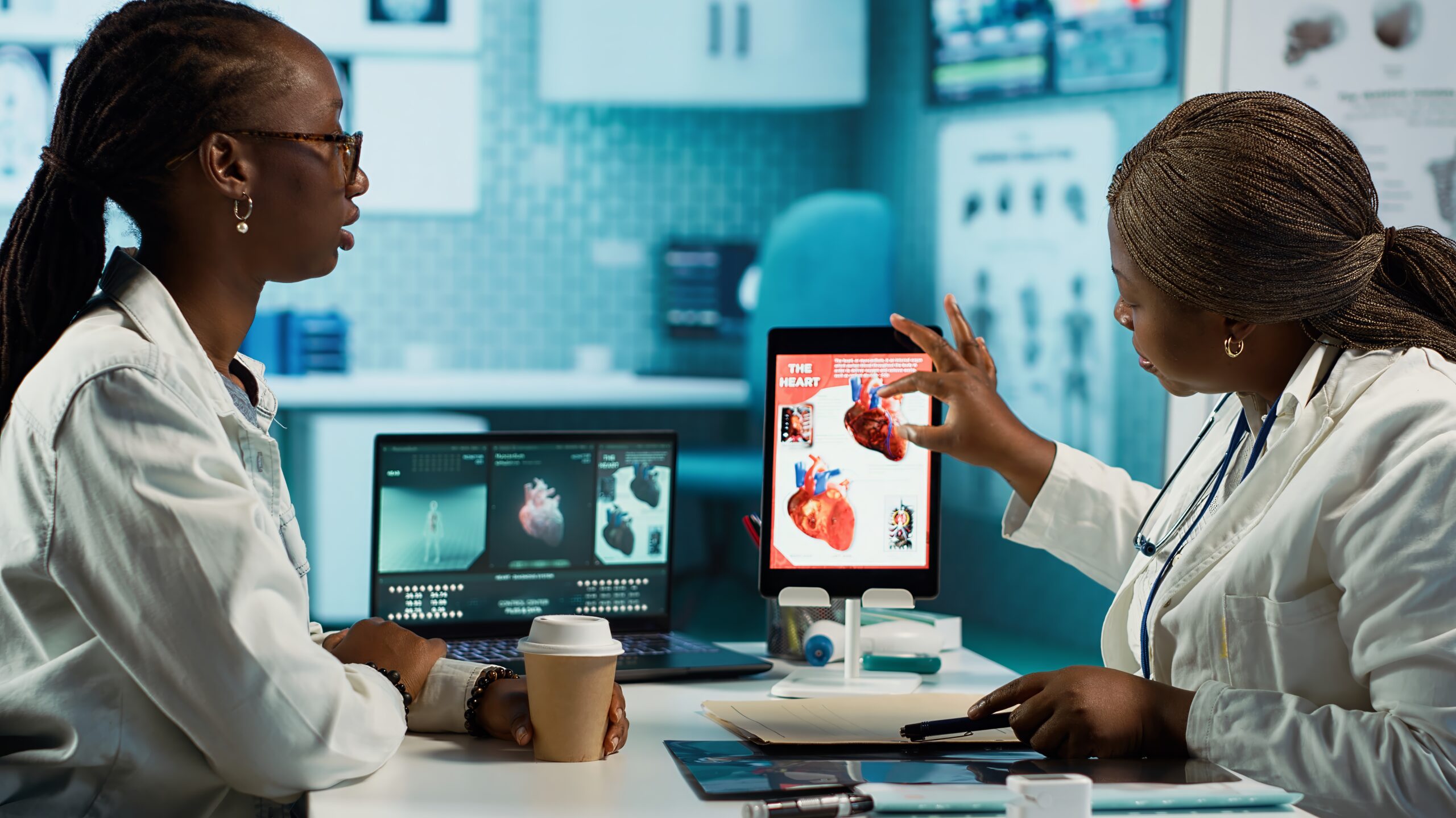 Medical office scene of a doctor and patient evaluating cardiology test results